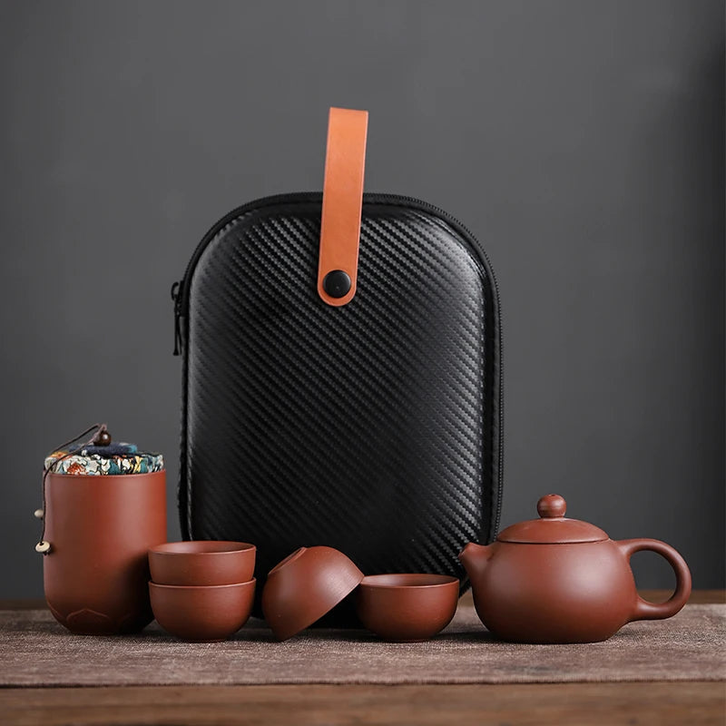 Tea set with black carrying case on a wooden surface