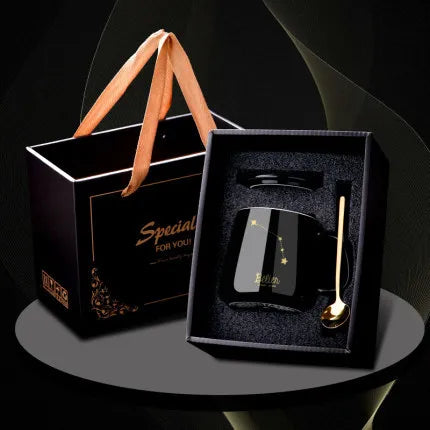 Black gift box with a bottle and spoon on a dark background