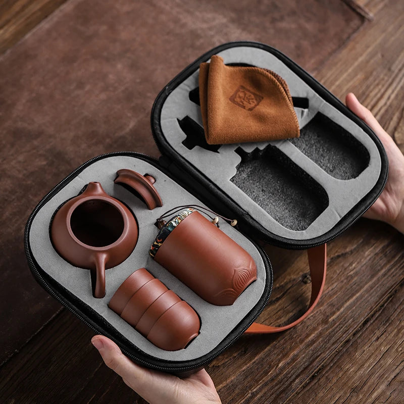 Tea set in a black carrying case on a wooden surface