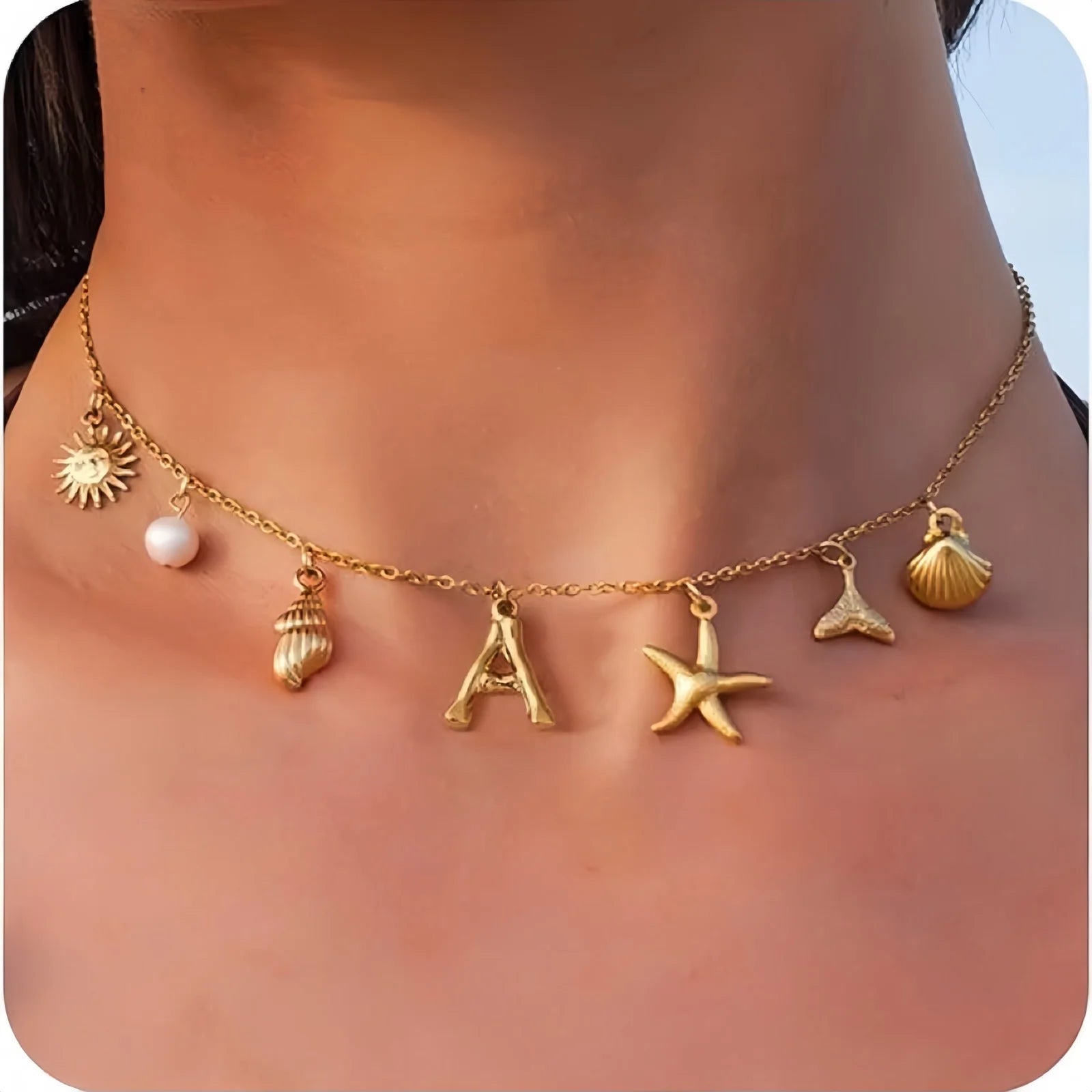 Gold necklace with various charms on a person's neck